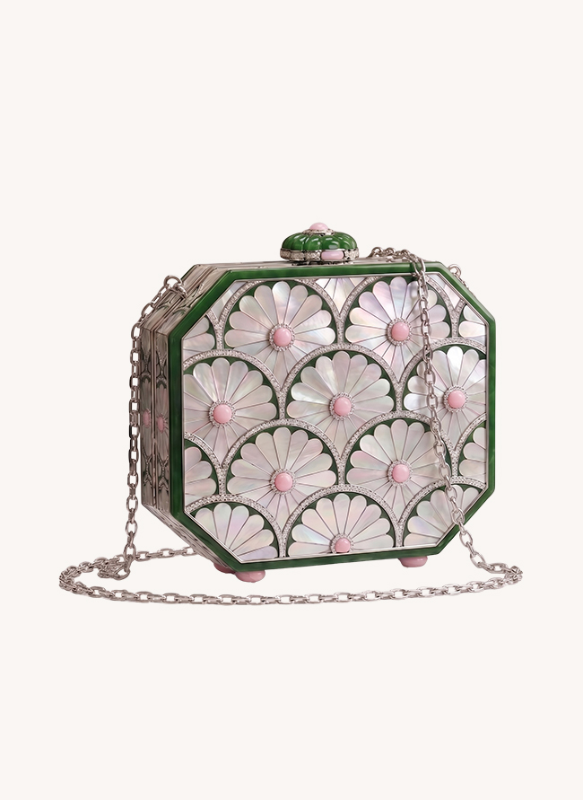 La Marguerite seen at an angle, its mother-of-pearl daisies set with pink opal centres, jade frame and silver chain