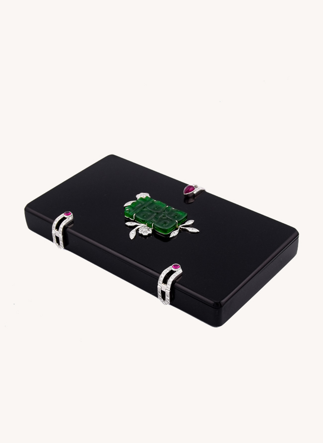 Fumoir Prunus cigarette case at an angle, showing the carved jade panel and diamond-set ruby catches