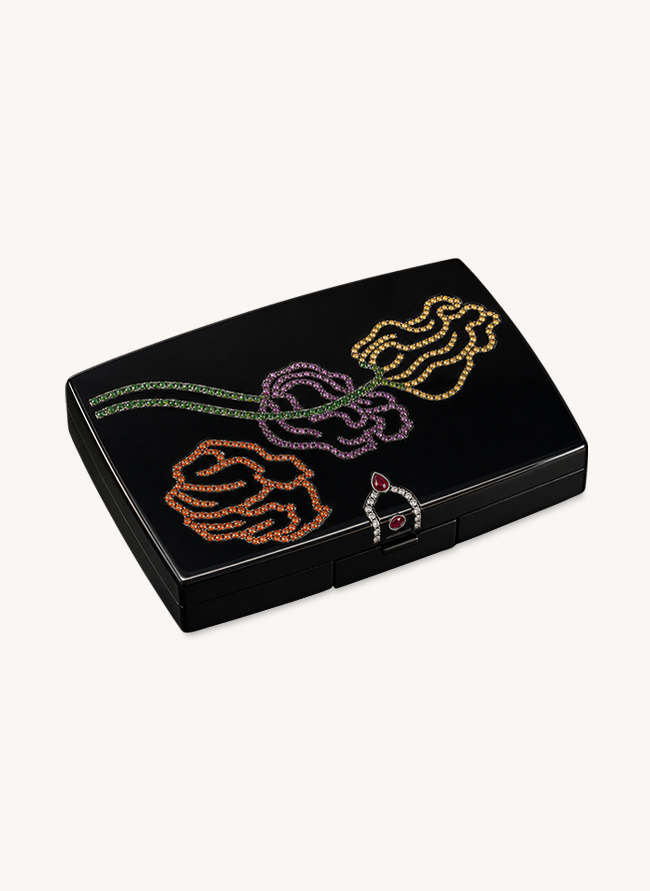 Poudrier Trois Roses compact in black jade with three roses set in yellow, pink and orange sapphires on tsavorite stems and a ruby clasp