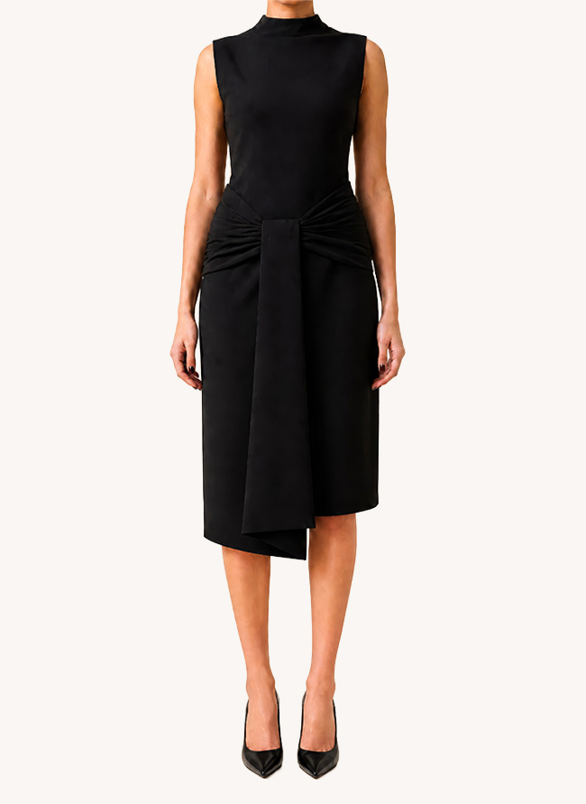 Front view of L'Aigue-Marine, a sleeveless black cocktail dress with high neck and draped sash at the waist